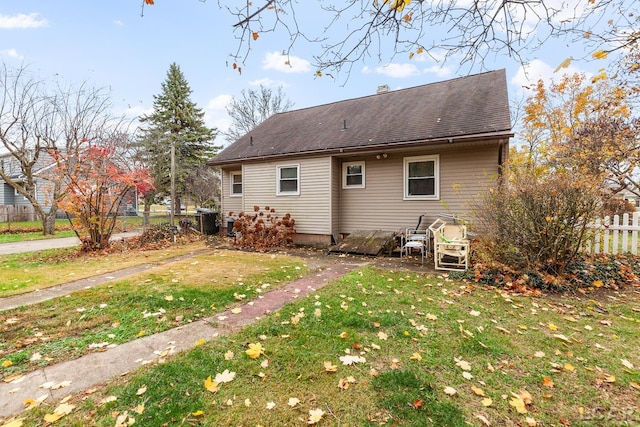 view of side of home with a lawn