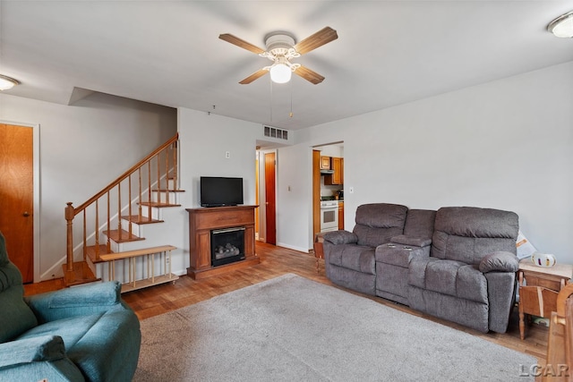 living room with ceiling fan and hardwood / wood-style flooring