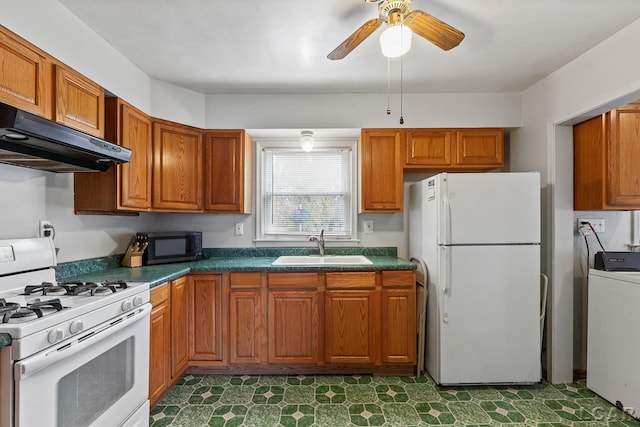 kitchen with white appliances, ceiling fan, exhaust hood, sink, and washer / clothes dryer