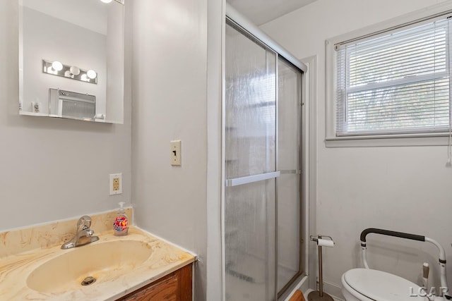 bathroom with vanity, toilet, and walk in shower