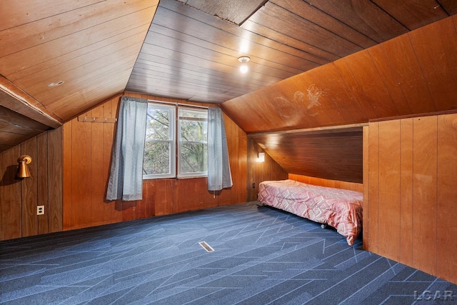 unfurnished bedroom featuring wooden ceiling and wooden walls