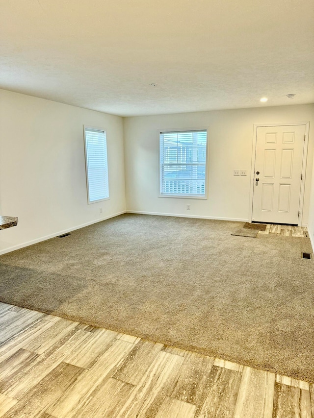 unfurnished living room with carpet floors