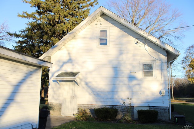 view of side of home with central AC