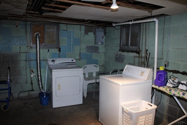 clothes washing area with separate washer and dryer and electric panel