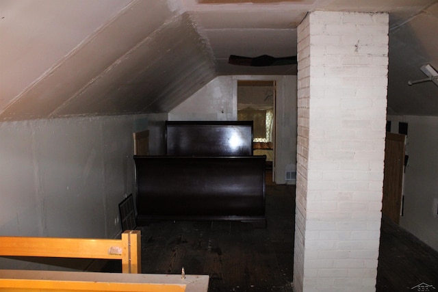 stairs with vaulted ceiling and hardwood / wood-style flooring