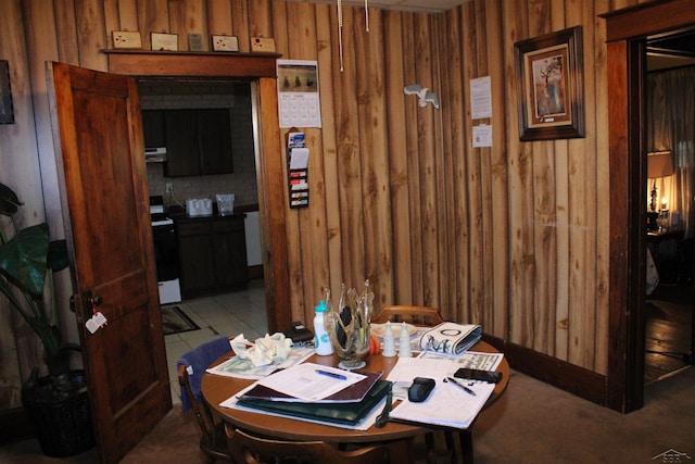 tiled dining area featuring wooden walls