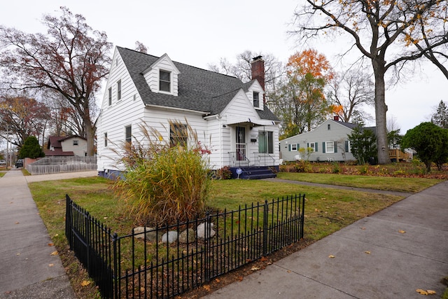 new england style home featuring a front lawn