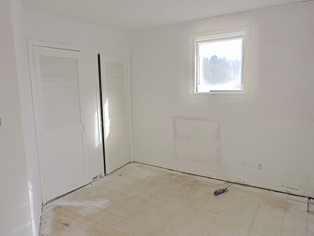 456 Leta Ave, Flint, MI 48507 - unfurnished bedroom featuring light flooring and a closet
