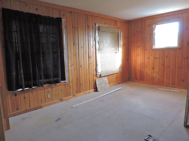 456 Leta Ave, Flint, MI 48507 - empty room featuring wood walls, baseboards, and concrete floors