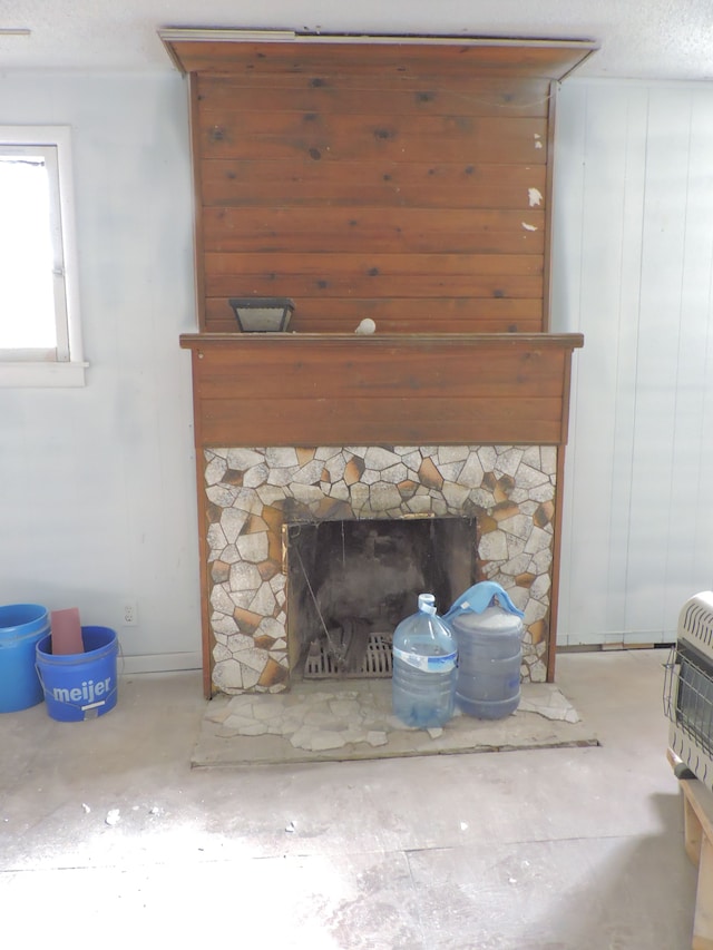 456 Leta Ave, Flint, MI 48507 - detailed view of a stone fireplace, concrete flooring, and heating unit