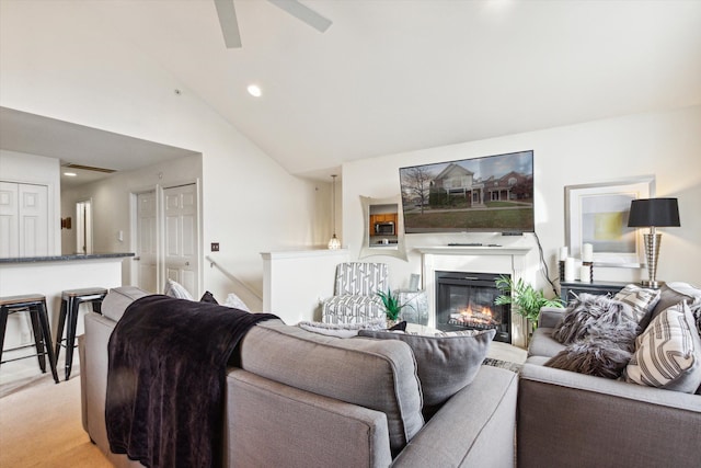 carpeted living room with high vaulted ceiling