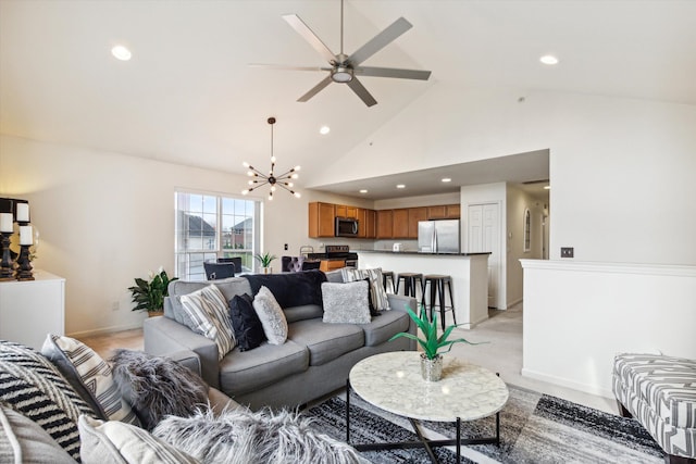 living room featuring high vaulted ceiling and ceiling fan with notable chandelier