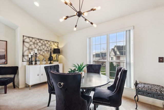 dining space with light carpet, an inviting chandelier, and lofted ceiling