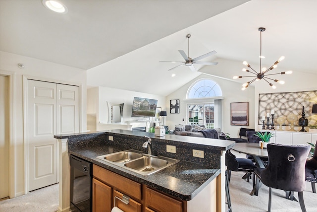 kitchen with light carpet, vaulted ceiling, sink, pendant lighting, and dishwasher