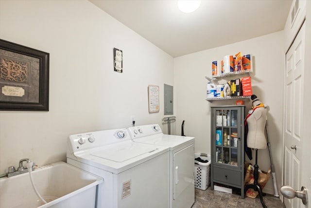 laundry area featuring washing machine and clothes dryer, electric panel, and sink