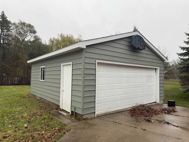 detached garage featuring fence