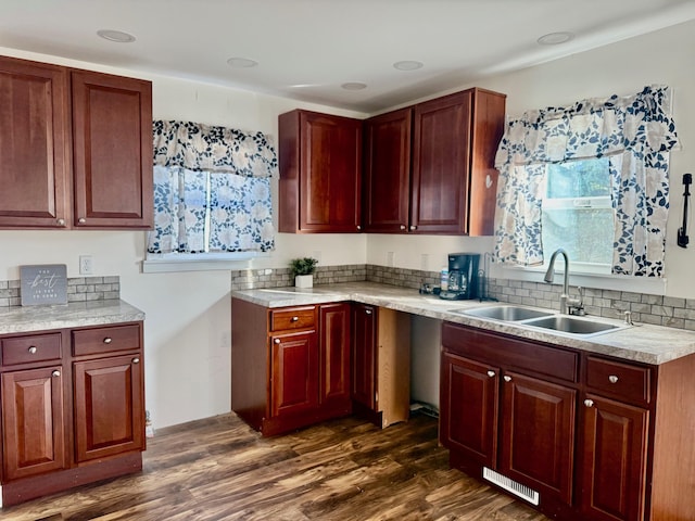 kitchen featuring dark wood-style floors, visible vents, light countertops, and a sink