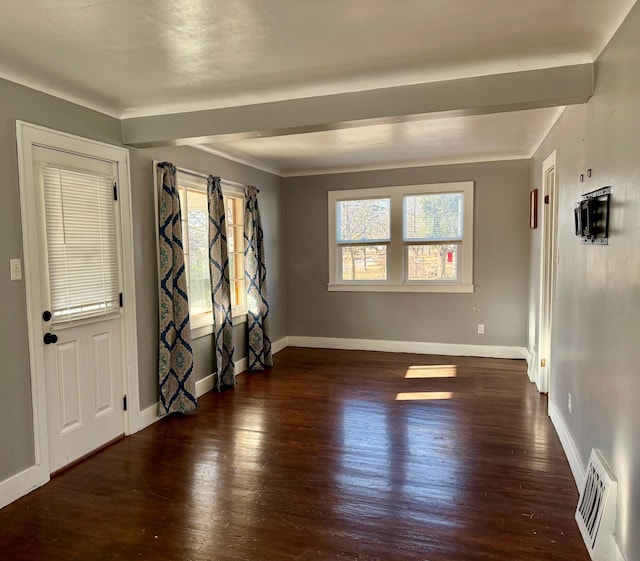 interior space with wood finished floors, visible vents, and a healthy amount of sunlight