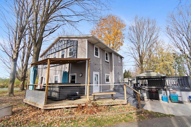 view of property exterior with a gazebo and a deck