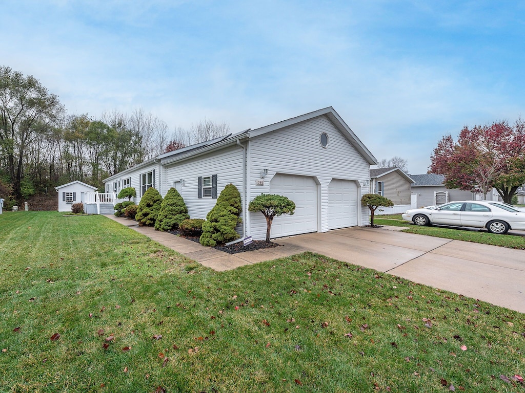 view of side of property with a yard and a storage shed