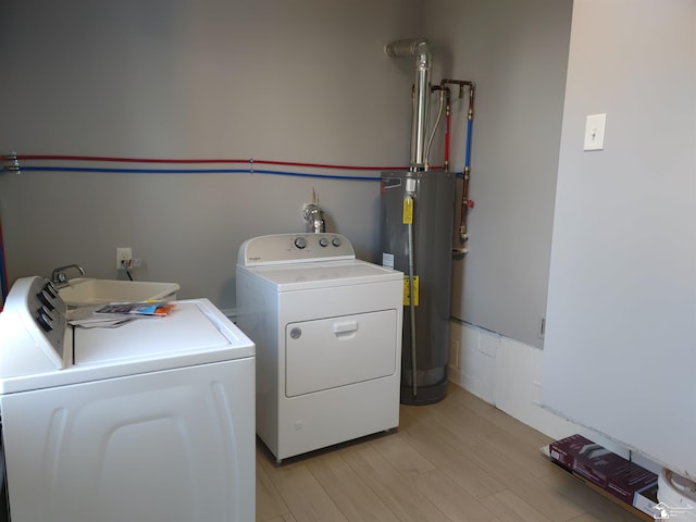 113 Walnut St, Brooklyn, MI 49230 - laundry area featuring electric water heater, washing machine and clothes dryer, and light wood finished floors