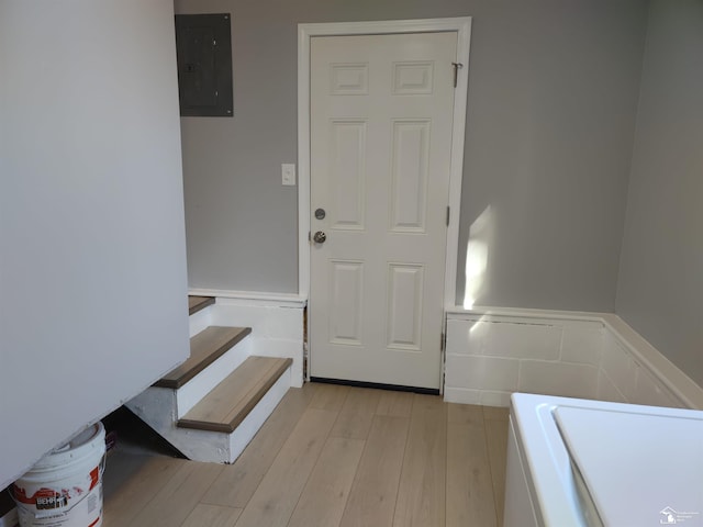 113 Walnut St, Brooklyn, MI 49230 - laundry room featuring electric panel, a wainscoted wall, and light wood-style floors