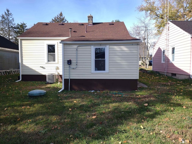 113 Walnut St, Brooklyn, MI 49230 - back of house with a yard, a shingled roof, cooling unit, and a chimney