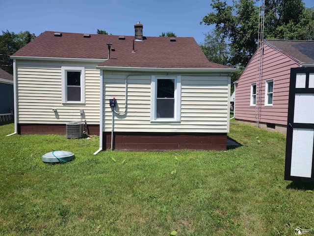 113 Walnut St, Brooklyn, MI 49230 - rear view of house featuring a lawn, a shingled roof, and a chimney