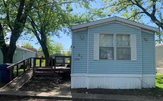 view of side of home with a wooden deck