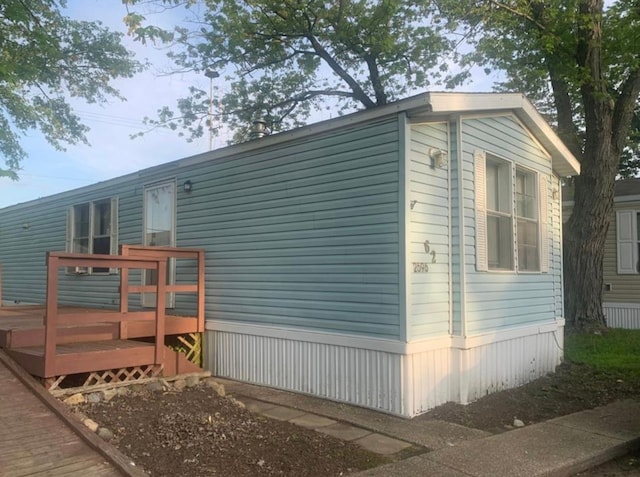 view of property exterior featuring a deck