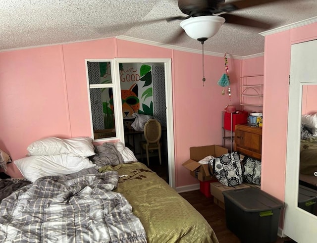 bedroom with a textured ceiling, ceiling fan, lofted ceiling, and ornamental molding