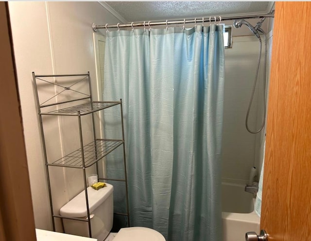 bathroom featuring a textured ceiling, shower / tub combo, and toilet