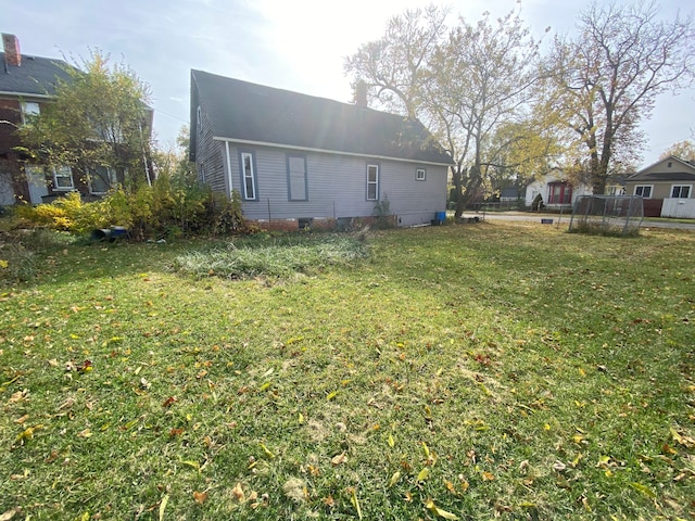 rear view of property with a lawn