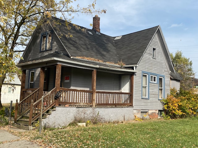 exterior space with a porch and a front yard