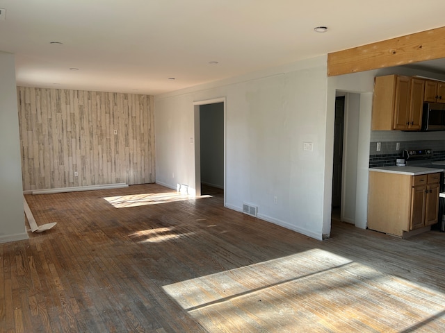 unfurnished room featuring wood walls and light hardwood / wood-style flooring