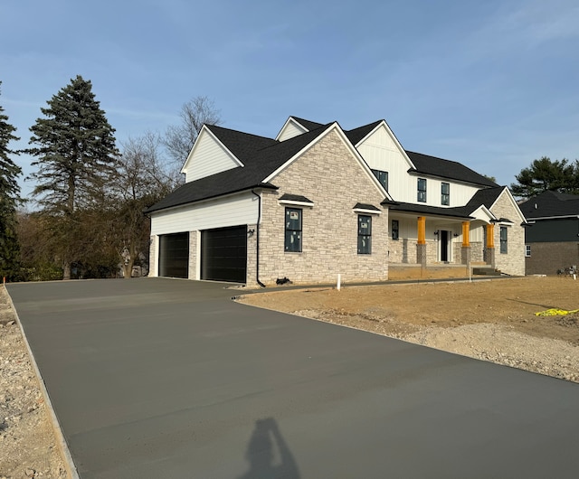 view of front of home featuring covered porch and a garage