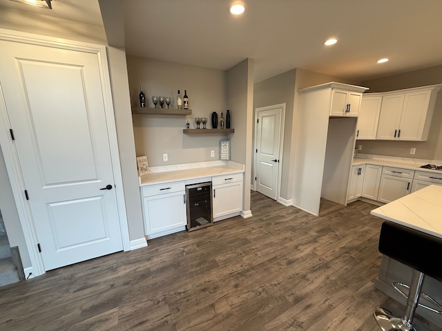 kitchen with white cabinets, beverage cooler, and dark hardwood / wood-style floors