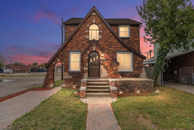 tudor home with a yard