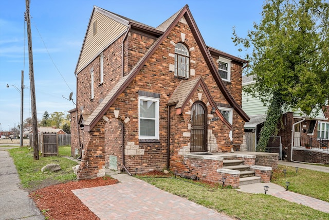 tudor house featuring a front yard