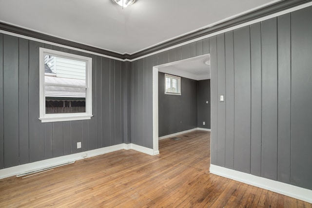 spare room featuring hardwood / wood-style floors and ornamental molding