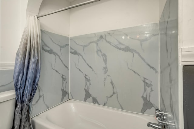 bathroom featuring toilet and shower / bathtub combination with curtain