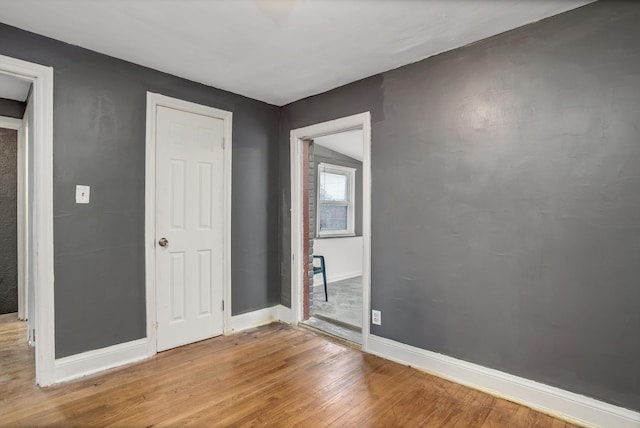 unfurnished room featuring wood-type flooring