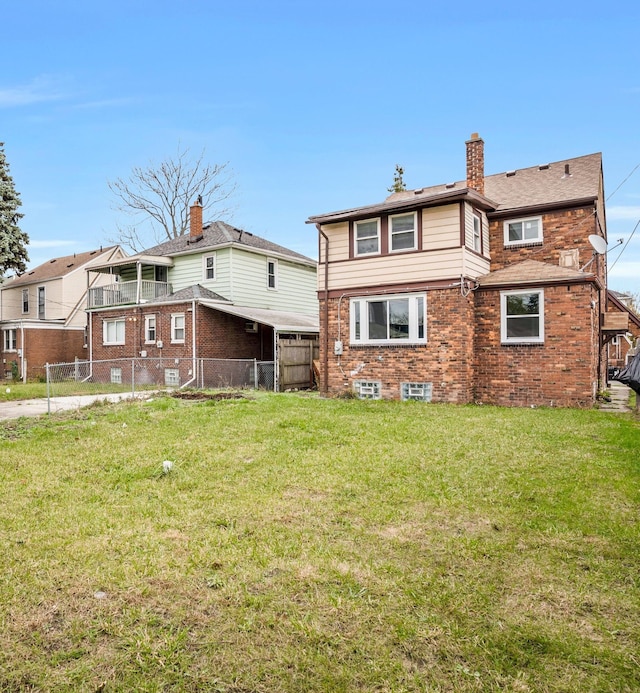 rear view of house with a lawn