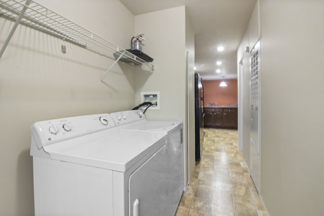 clothes washing area featuring separate washer and dryer