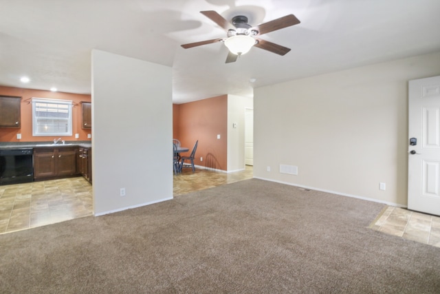 unfurnished living room featuring light colored carpet, ceiling fan, and sink