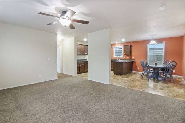 living room featuring ceiling fan and light colored carpet