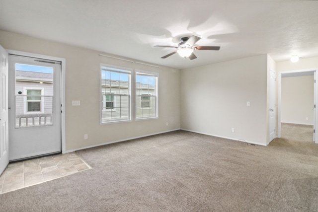 unfurnished living room with light colored carpet and ceiling fan