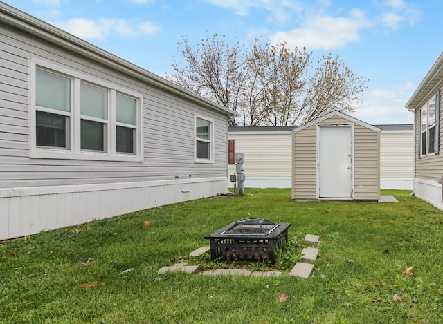 view of yard featuring a shed and an outdoor fire pit