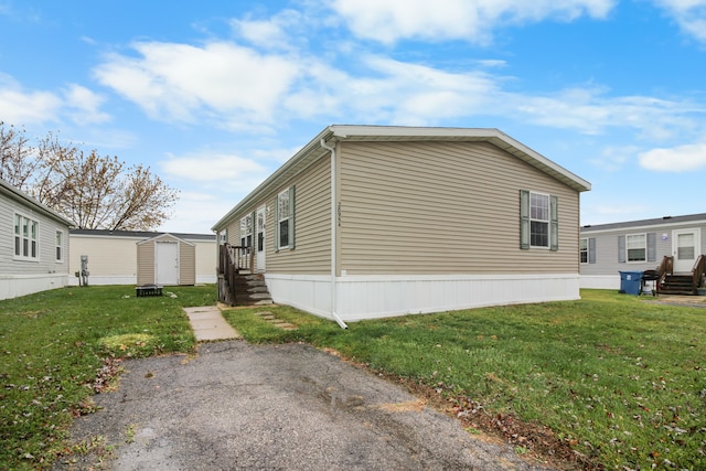 view of property exterior featuring a storage shed and a lawn