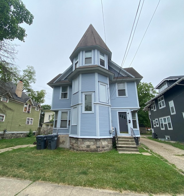 victorian house with a front yard